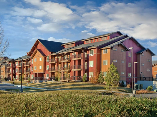 Exterior view of the multi-story Club Wyndham Steamboat Springs resort building on a bright, sunny day, an excellent destination for summer getaways in Colorado.