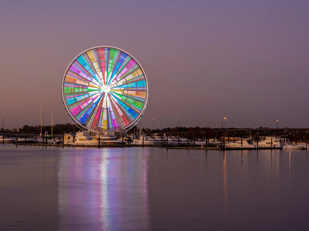 The Capital Wheel at National Harbor, Maryland, illuminated at twilight.
