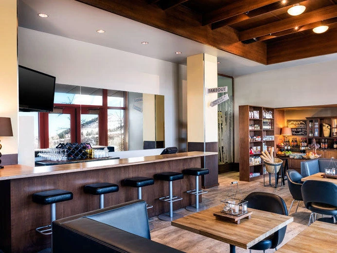 View of the modern and stylish bar and lounge area at the Westin Riverfront, a perfect spot to relax during summer getaways in Colorado.