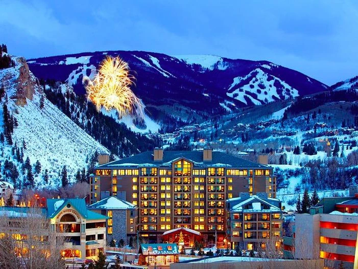 Exterior view of the Westin Riverfront resort by the river, nestled in the mountains and popular for summer getaways in Colorado.