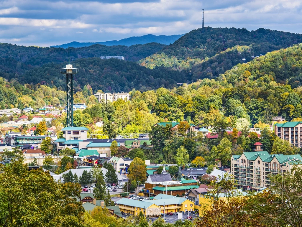 Scenic aerial view of the town nestled in the Great Smoky Mountains, featuring the Gatlinburg Space Needle.