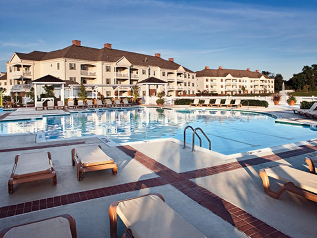 Large outdoor swimming pool and lounge chairs at Wyndham Governor's Green resort.