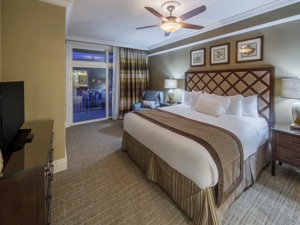 Relax in a spacious bedroom at this timeshare in gatlinburg, featuring a king bed and balcony view.