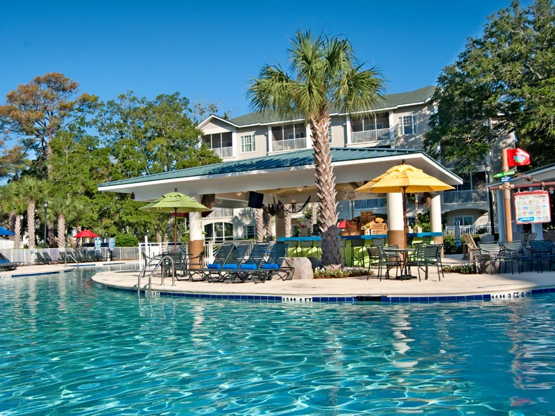 Enjoy a summer vacation at this outdoor poolside bar with yellow umbrellas and palm trees.