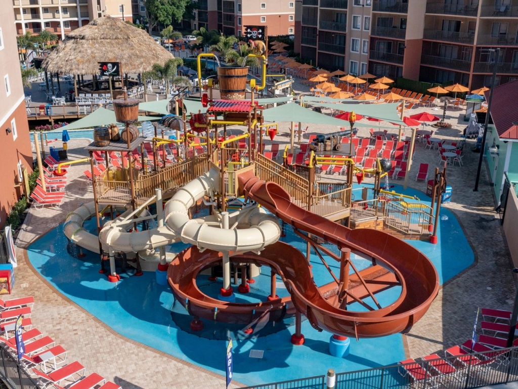Pirate-themed water park at Westgate Lakes Resort and Spa featuring winding water slides, pool loungers, and a tiki bar.