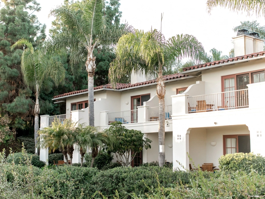White stucco buildings with balconies at Four Seasons Aviara, a beautiful spot to weigh fractional ownership vs timeshare.