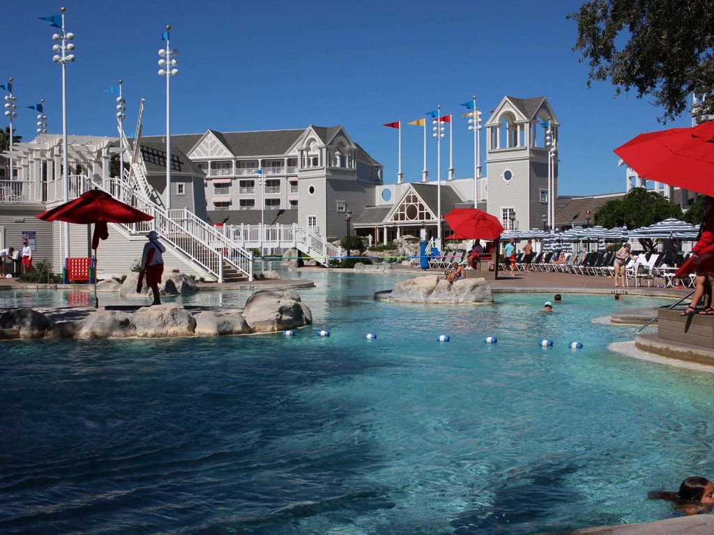 Lagoon-style pool with rocks and a windmill in the background at Stormalong Bay in Disney's Yacht & Beach Club Resort.