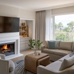 Modern resort living room with a fireplace and balcony view, ideal when considering fractional ownership vs timeshare.