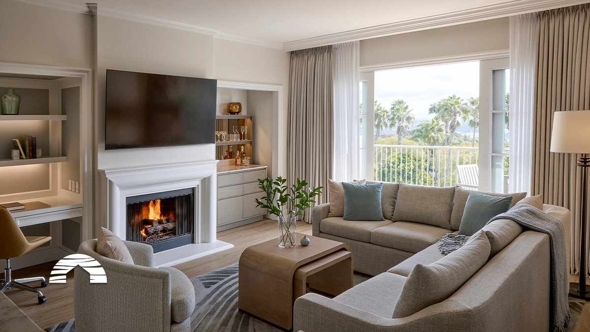 Modern resort living room with a fireplace and balcony view, ideal when considering fractional ownership vs timeshare.