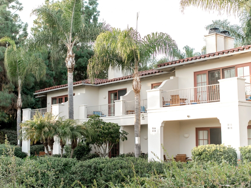 Spanish-style white resort villas with balconies and palm trees at Aviara in Carlsbad.
