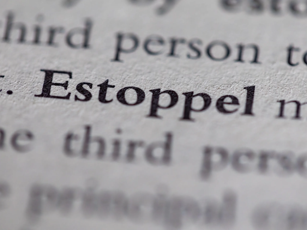 Close-up of bold serif text on white paper featuring the phrase estoppel certificate in a legal document.