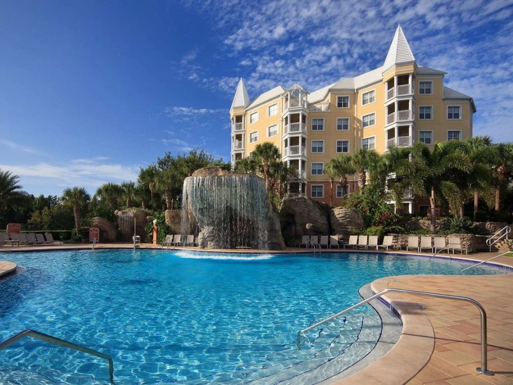 Large resort pool with a rock waterfall at a deeded timeshare at Hilton Grand Vacations SeaWorld.