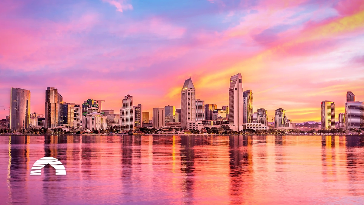 San Diego skyline at sunset reflected in calm bay waters, a popular destination for timeshare in san diego ownership